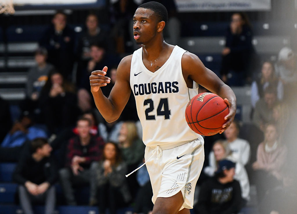 Justin Shaw dribbles down the court